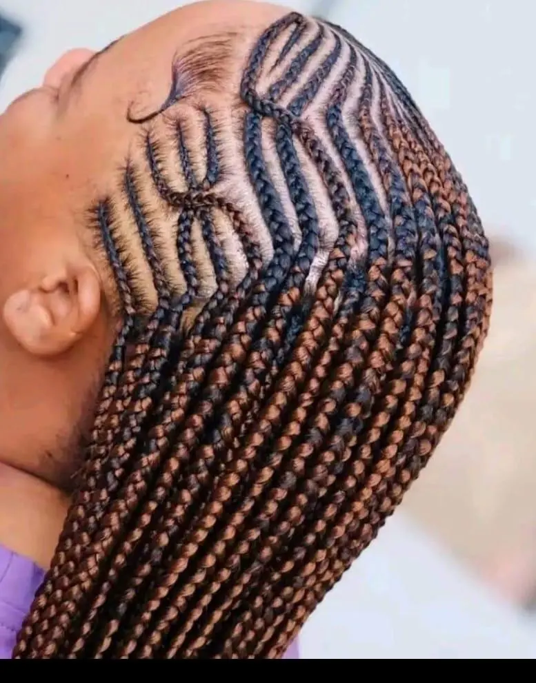 Detailed cornrow pattern flowing into long braids by Empress Royal Braids & Beauty